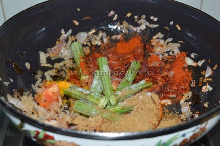 Spices, onion, tomato and drumstick getting cooked