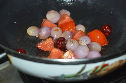 Pearl onions, red chilied, ginger and tomatoes getting cooked