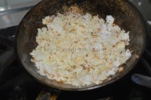 Grated coconut getting fried in ghee/clarified butter