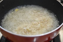 Grated coconut, crushed cardamom pods and shajeera in sugar syrup