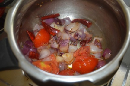 Onions, tomato and red chilies getting cooked